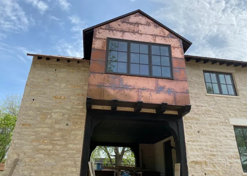 Copper metal panel facade on a stone building for Metal Roof Coating in Red Chute