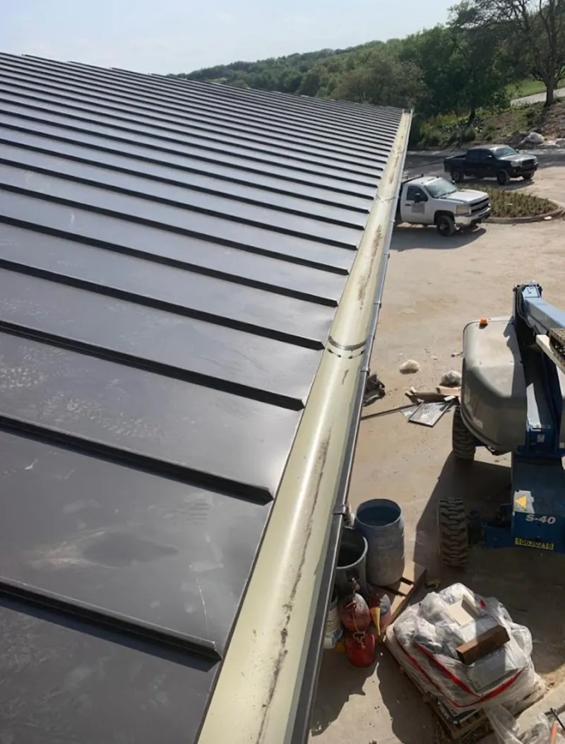 Standing seam panel and gutter detail on a metal roofing jobsite in Red Chute